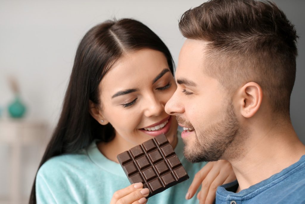 A couple eating a mushroom chocolate bar together