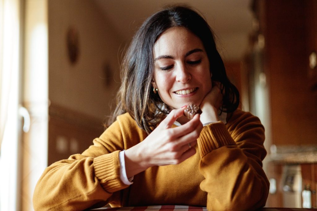 A lady eating nootropic mushroom chocolate