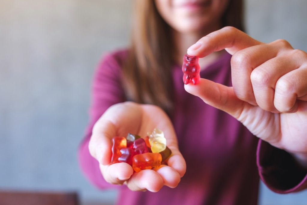 A lady eating nootropic mushroom gummies
