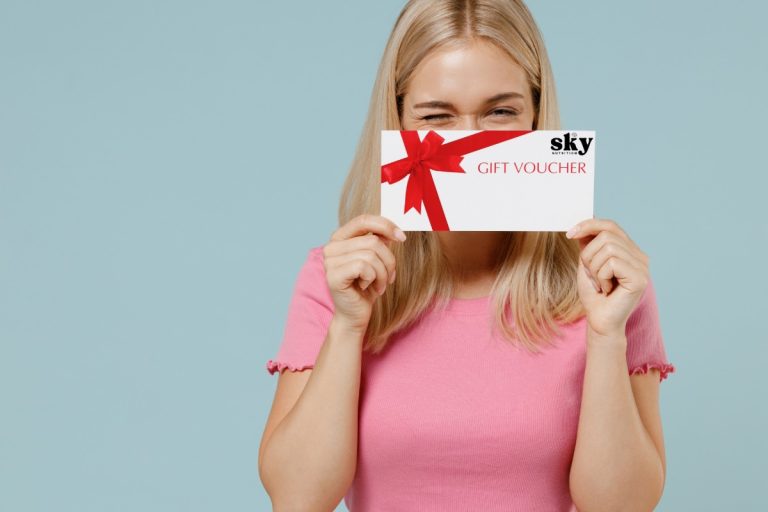 A lady holding a coupon of sky nutrition mushroom gummies