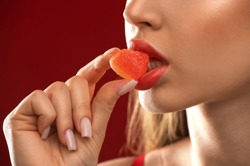 A lady is eating amanita muscaria mushroom gummy