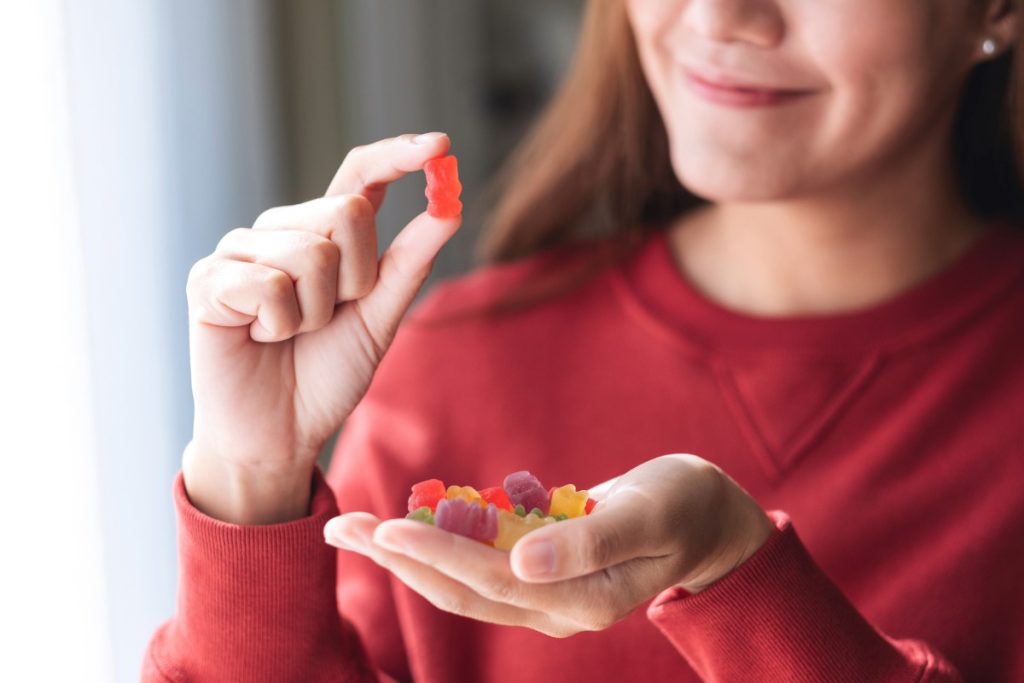 A lady is eating mushroom infused gummies