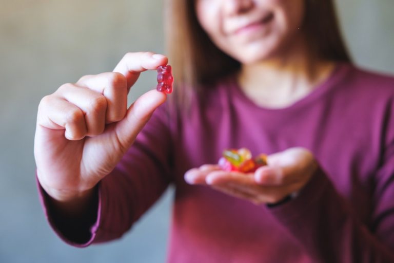 A lady is showing the mushroom gummies she takes daily