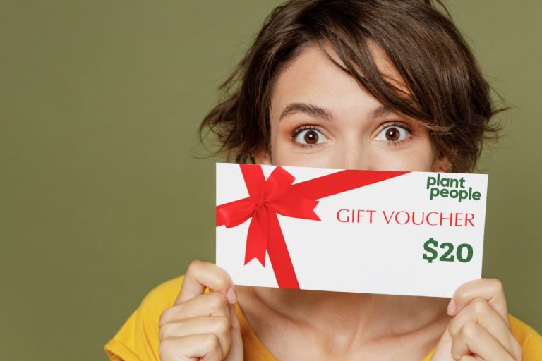 A lady showing gift voucher of plant people mushroom gummies