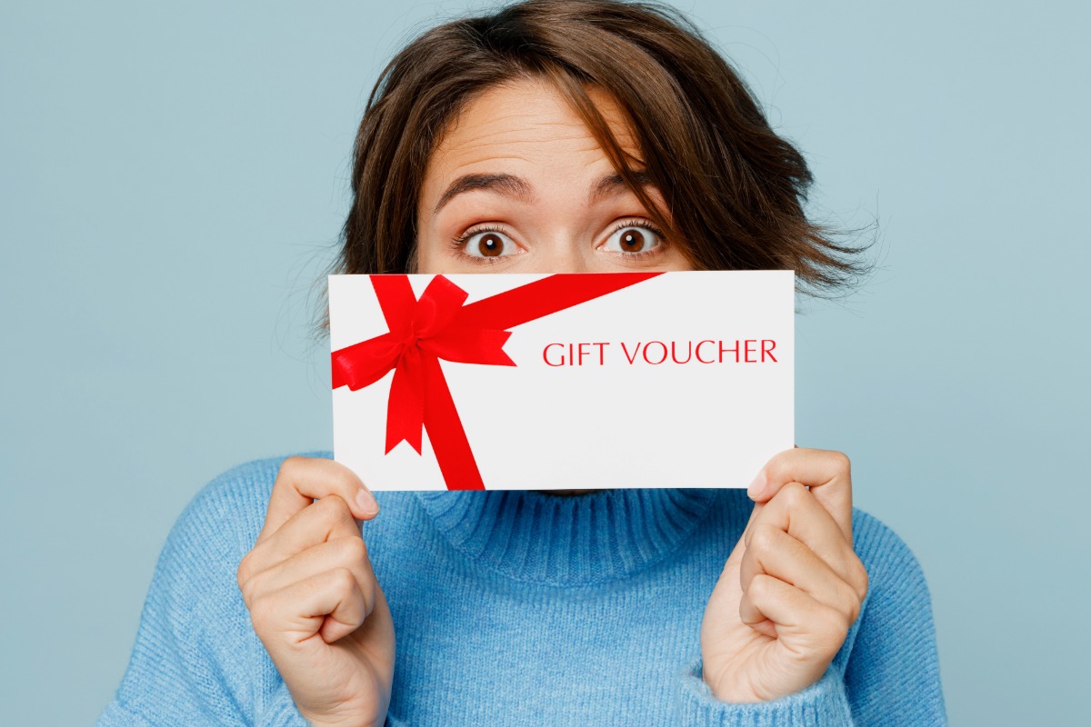 A lady showing gift voucher