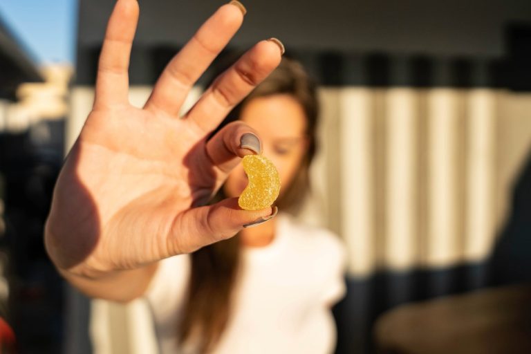A lady showing mushroom gummy