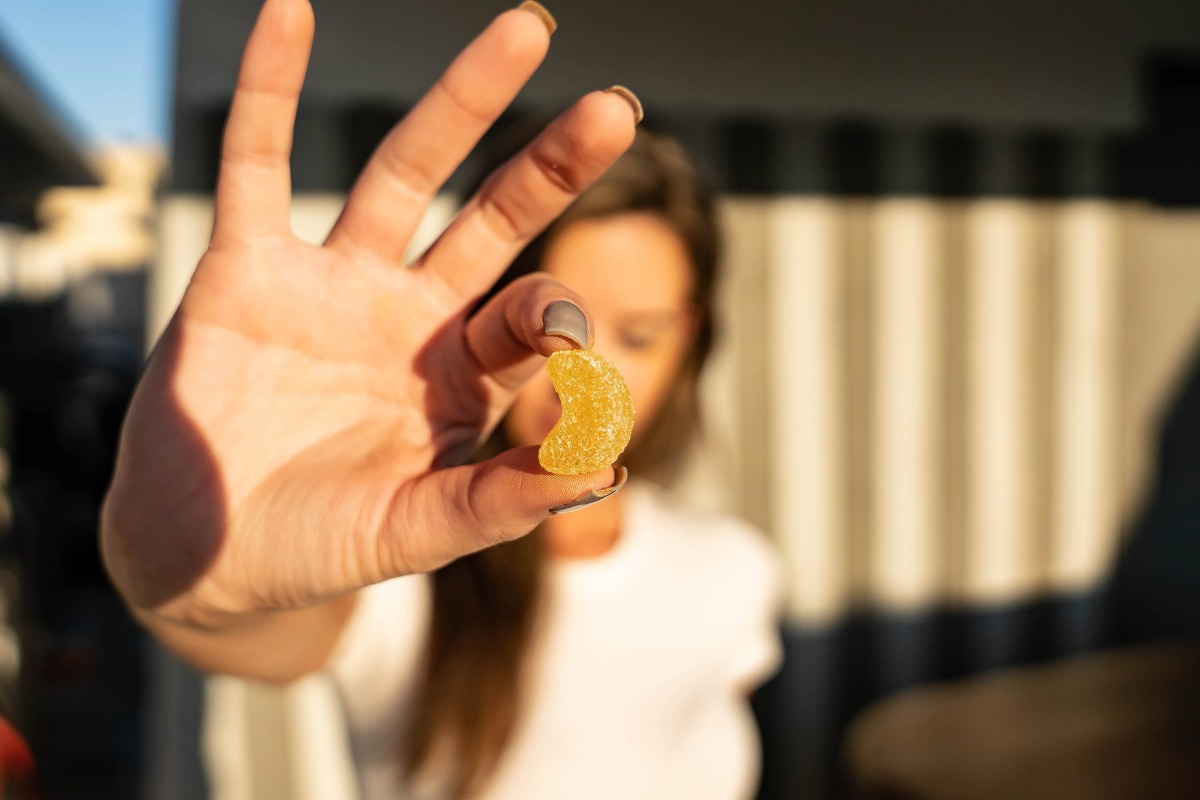 A lady showing mushroom gummy