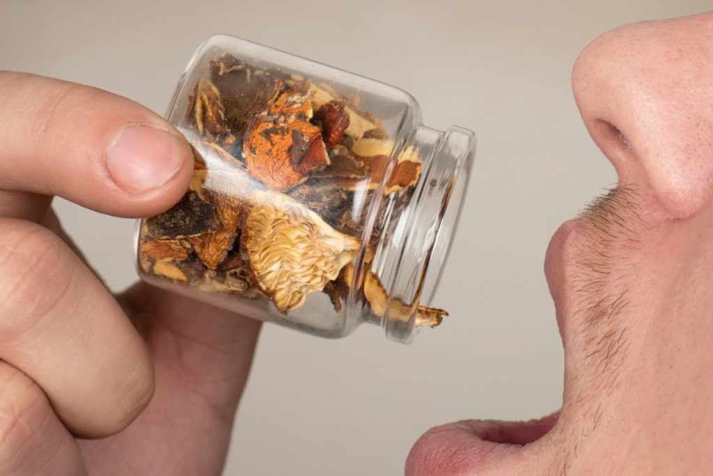 A man eating magic mushrooms