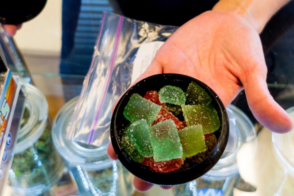 A person holding flavored mushroom gummies