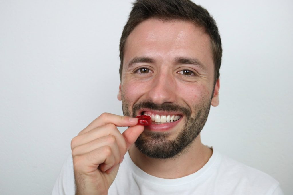 A person is eating mushroom gummy